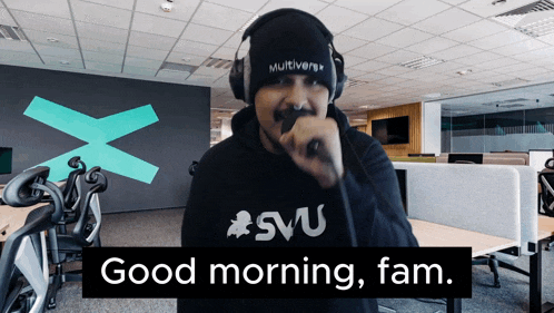 a man wearing headphones and a svu shirt says " good morning fam "