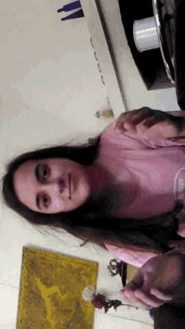 a woman wearing a pink shirt that says 100 % organic on it