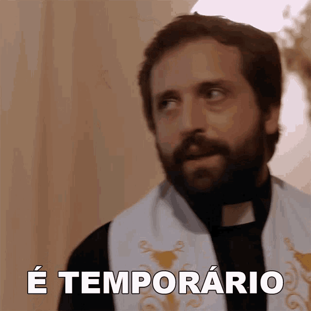 a man with a beard is wearing a white robe with the words e temporario written on it