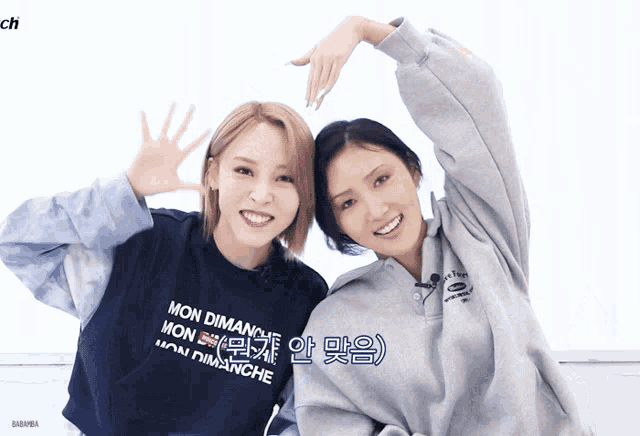 two women wearing sweatshirts that say mon dimanche on them