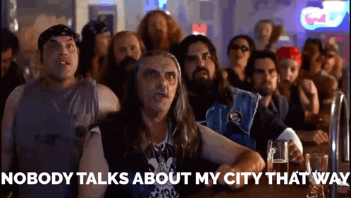 a group of men are sitting at a bar with the words nobody talks about my city that way