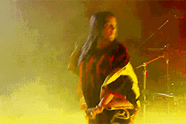 a woman in a plaid jacket is dancing on stage