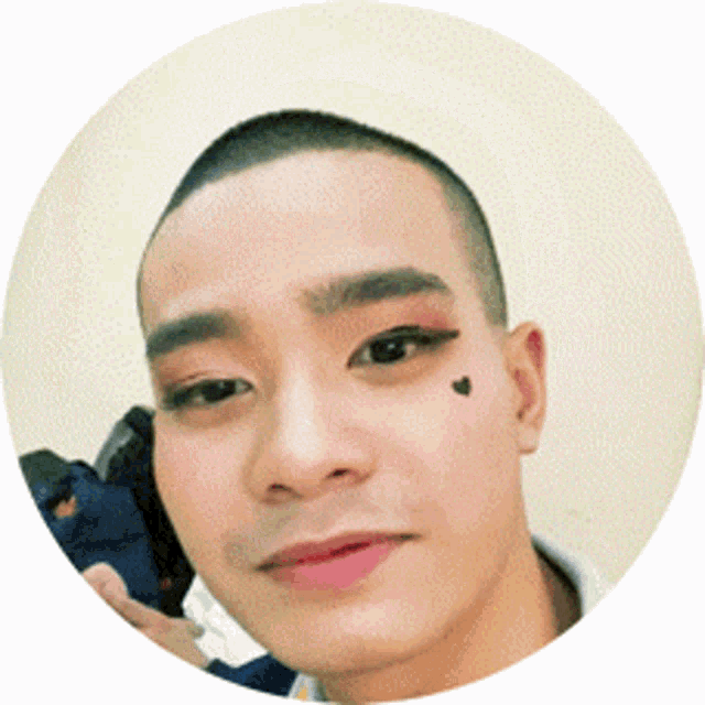 a man with a heart tattoo on his face