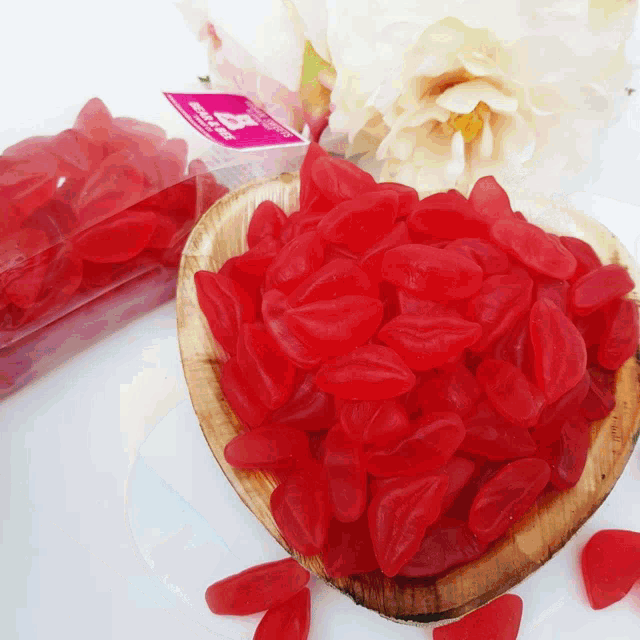 a wooden bowl filled with red gummy lips