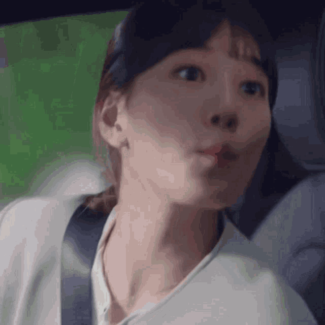 a close up of a woman 's face in a car
