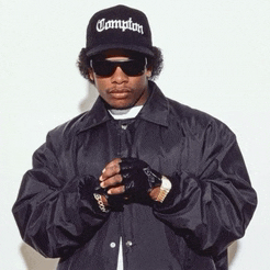 a man wearing a compton hat and a black jacket