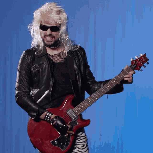 a man in a wig and sunglasses is holding a guitar