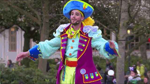 a man in a pirate costume stands in front of a crowd with his arms outstretched