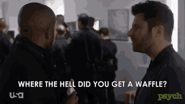 two men are talking in front of a crowd with the words where the hell did you get a waffle on the bottom