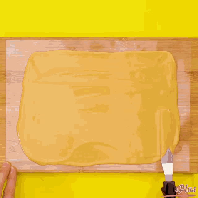 dark chocolate is being poured on a wooden board