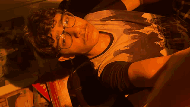 a young man wearing glasses and a shirt that says ' i love you '