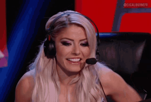 a woman is wearing headphones and a microphone while sitting in a chair .