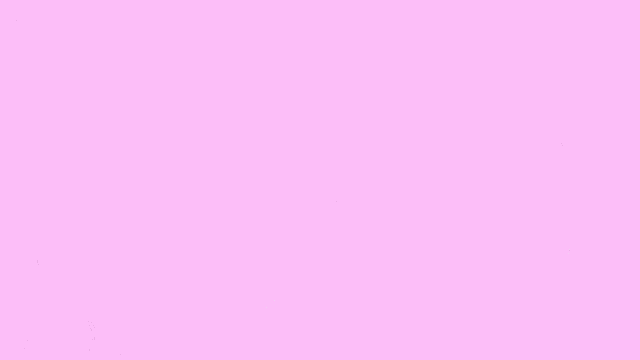 a man wearing glasses is sitting in a gaming chair with pink bubbles coming out of his eyes .