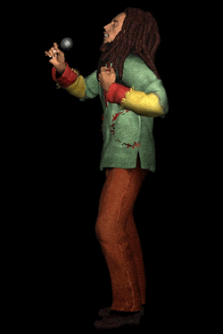a man with dreadlocks is singing into a microphone in a green shirt