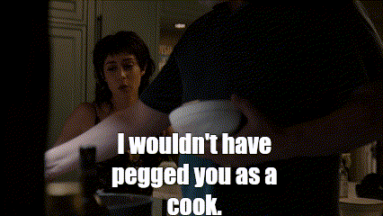 a man and woman in a kitchen with a caption that says i wouldn 't have pegged you as a cook .