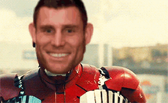 a man wearing a red iron man suit is smiling