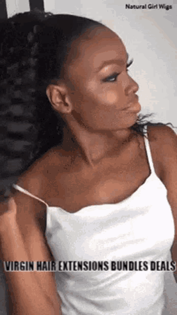 a woman in a white tank top is wearing a ponytail .
