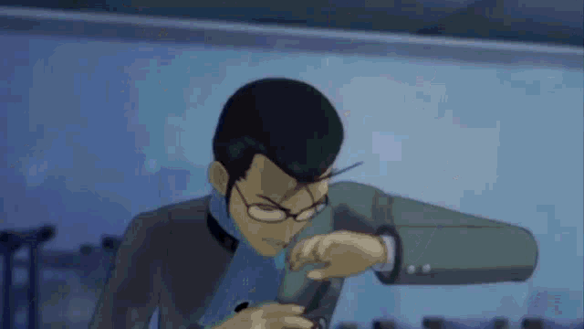 a man in a suit and glasses is holding a gun in his hand .