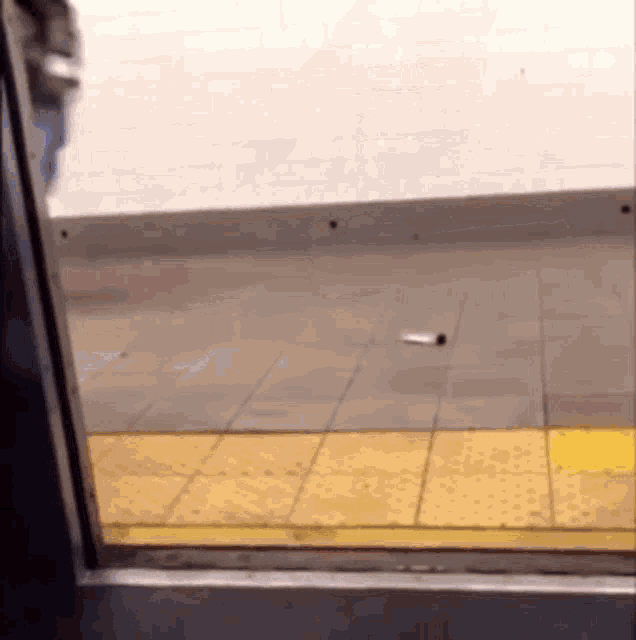 a bottle is laying on the ground in a subway