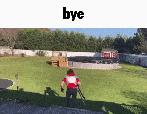 a man is running down a set of stairs in a backyard with a trampoline in the background .