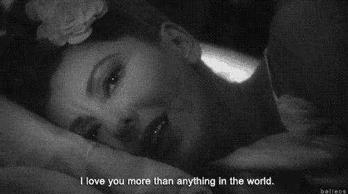 a black and white photo of a woman with a flower in her hair and the words i love you more than anything in the world