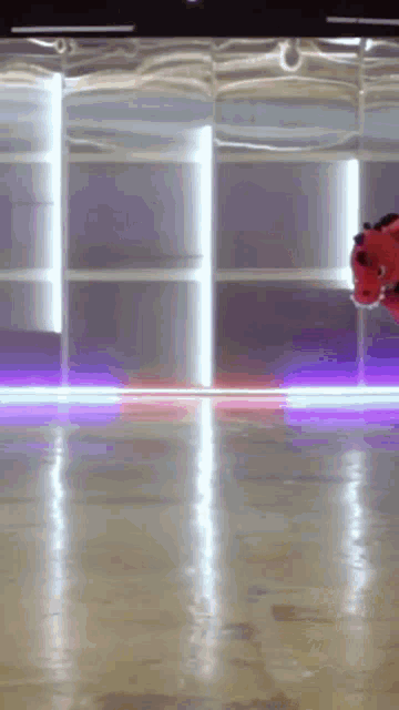 a red stuffed animal is flying through the air