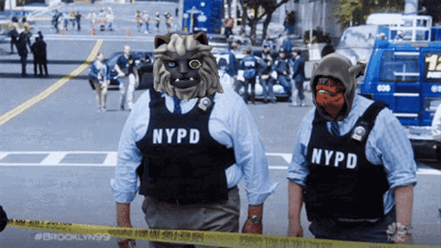 two nypd officers stand next to each other