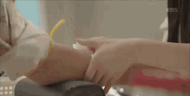 a close up of a person 's hand holding another person 's hand .