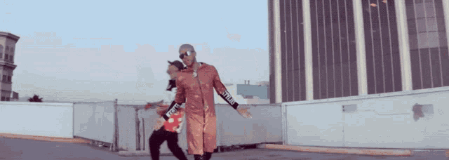 a man wearing a red jacket with the word supreme on the sleeves
