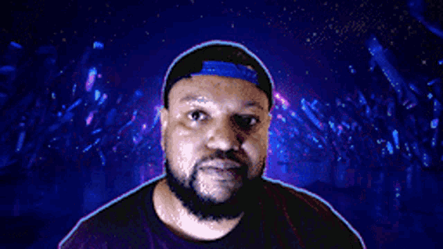 a man with a beard wearing a blue hat