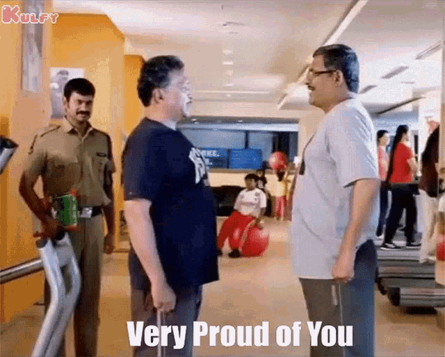 two men are standing next to each other in a gym and a police officer is standing behind them .