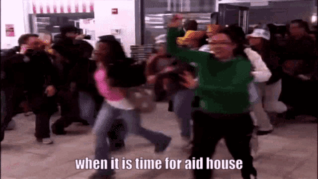 a woman in a green sweater is dancing in a crowd with the words when it is time for aid house below her
