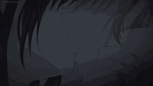 a man and a woman are kissing in a dark room with a kissanime logo in the corner