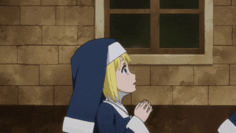 a nun is praying in front of a window in a brick building