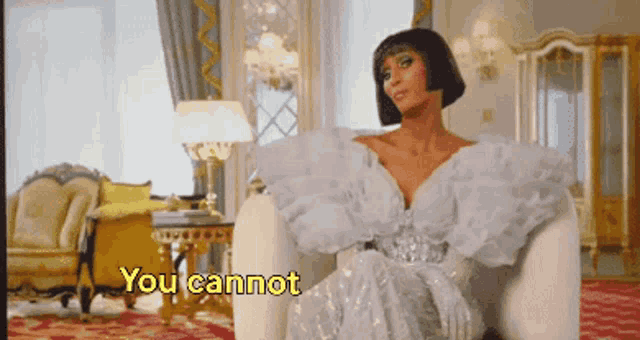 a woman in a white dress is sitting in a chair with the words " you cannot " above her