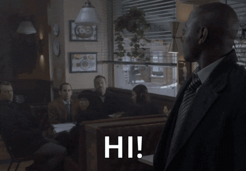 a man in a suit and tie says hi