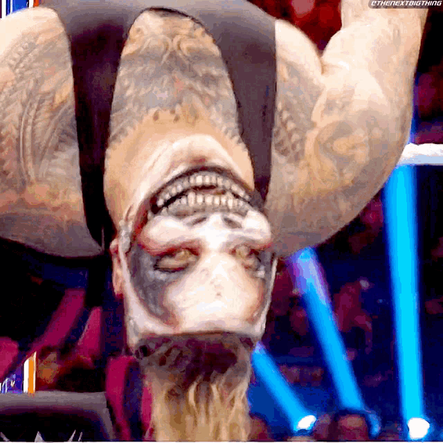 a man is upside down in a wrestling ring with the next thing written on the bottom right