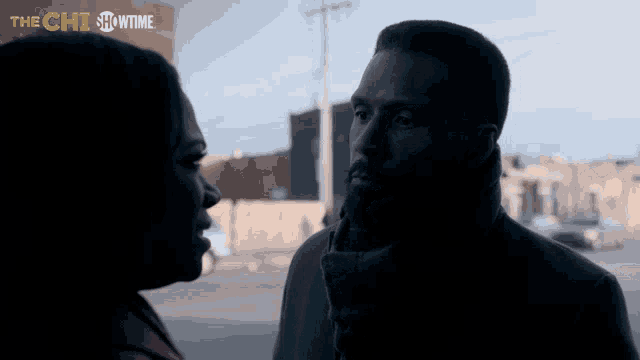 a man and a woman are looking at each other in front of a sign that says showtime