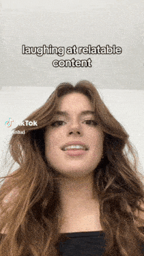 a woman is laughing at relatable content on a tiktok video