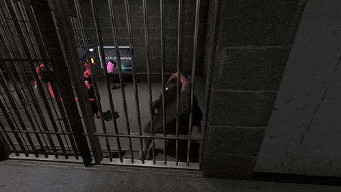 a man is behind bars in a jail cell with a sign that says " next to me "