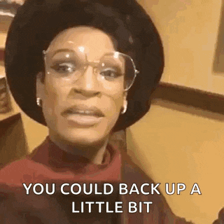 a woman wearing glasses and a hat is saying `` you could back up a little bit `` .
