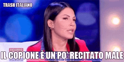 a woman in a red jacket is sitting in front of a microphone with the words trash italiano on the bottom