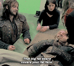 a man with a big fat beard is laying on a table