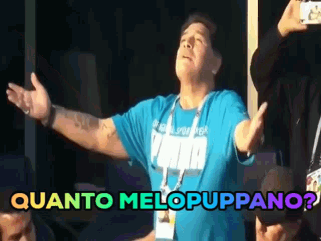 a man with his arms outstretched is wearing a puma shirt