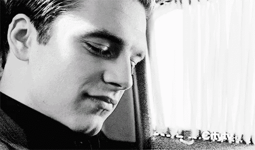 a close up of a man 's face in a black and white photo with a white background .