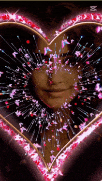 a woman 's face is surrounded by a heart of butterflies and sparkles