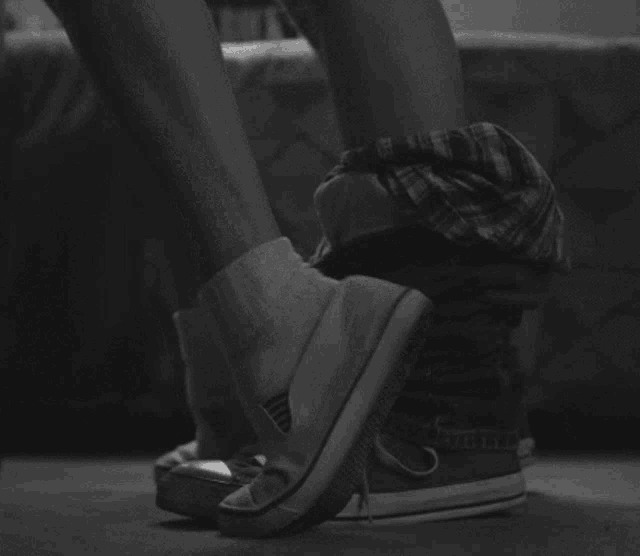 a person is taking off their converse shoes