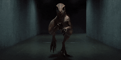 a dinosaur is sitting in a dark room with a concrete wall