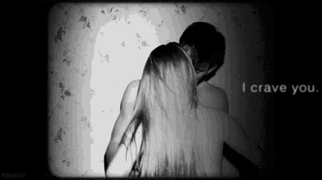 a black and white photo of a man and a woman kissing with the words i crave you above them .