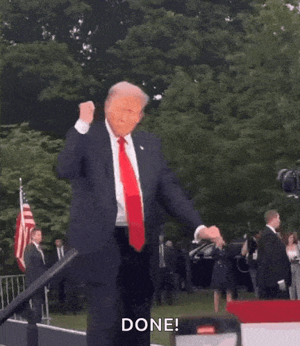donald trump is dancing on a stage in front of a crowd .